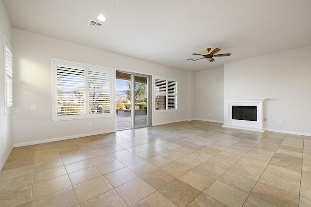 unfurnished living room featuring light tile patterned floors and ceiling fan