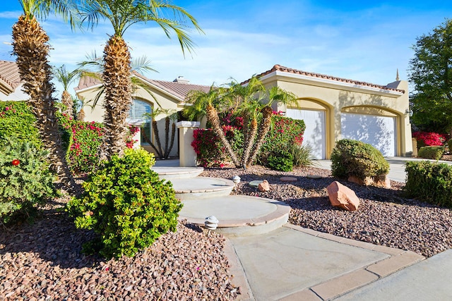 mediterranean / spanish home with a garage