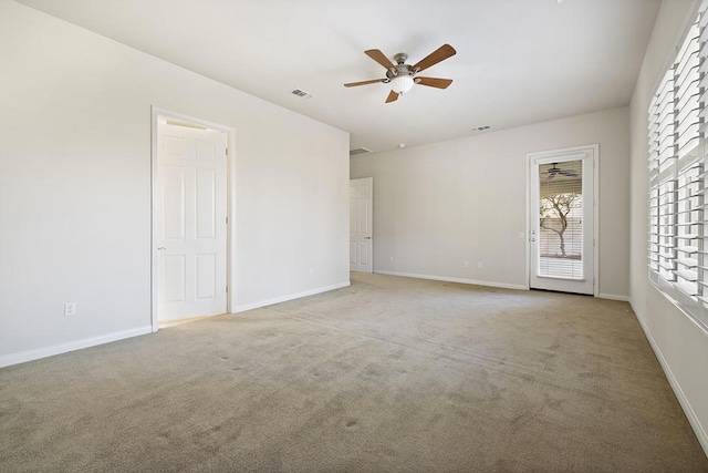 unfurnished room with light colored carpet and ceiling fan