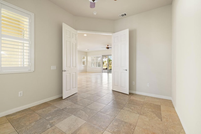 unfurnished room with ceiling fan