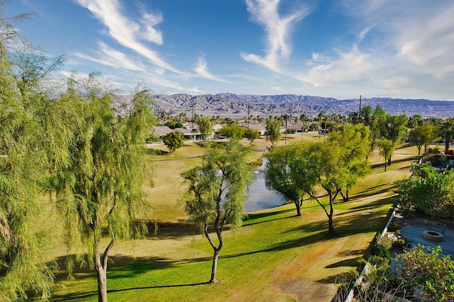 view of property's community with a yard and a water and mountain view