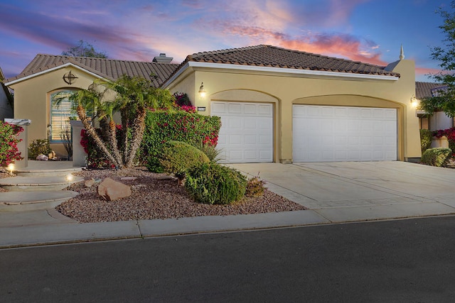 mediterranean / spanish-style home featuring a garage