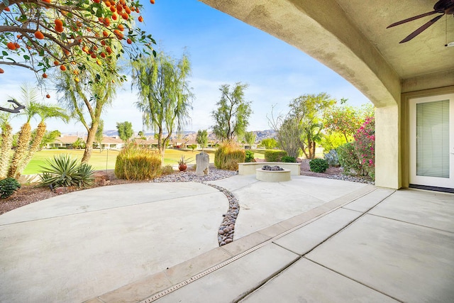 view of patio / terrace featuring ceiling fan and an outdoor fire pit