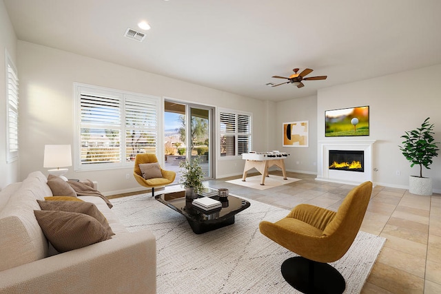 tiled living room with ceiling fan