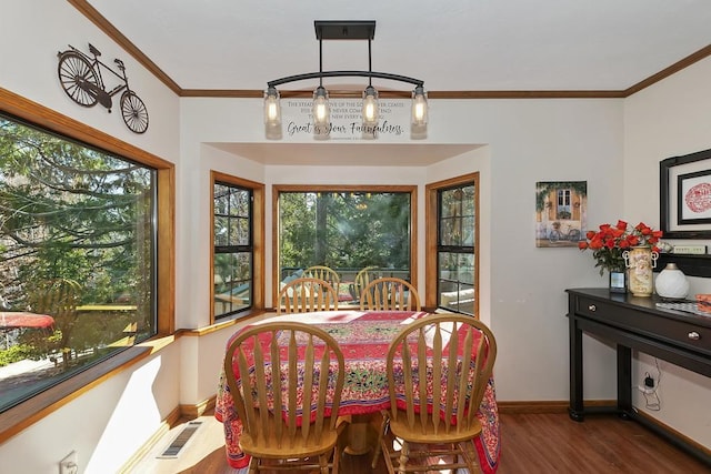 dining room featuring dark wood-type flooring and ornamental molding