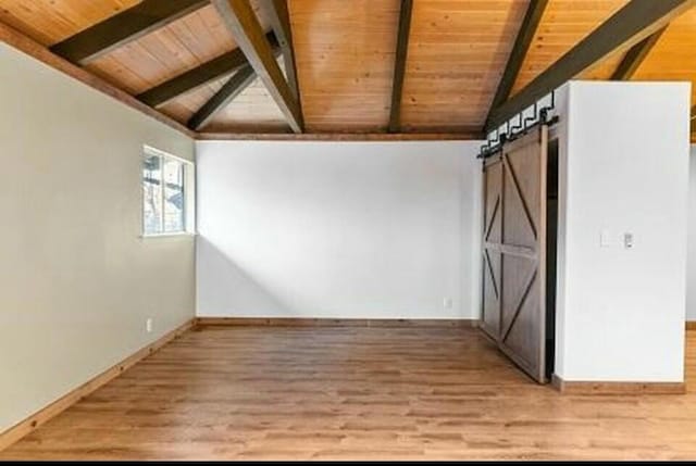 bonus room with wood ceiling, wood-type flooring, lofted ceiling with beams, and a barn door