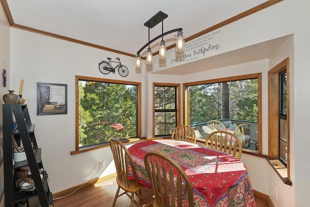 dining space featuring hardwood / wood-style flooring and ornamental molding