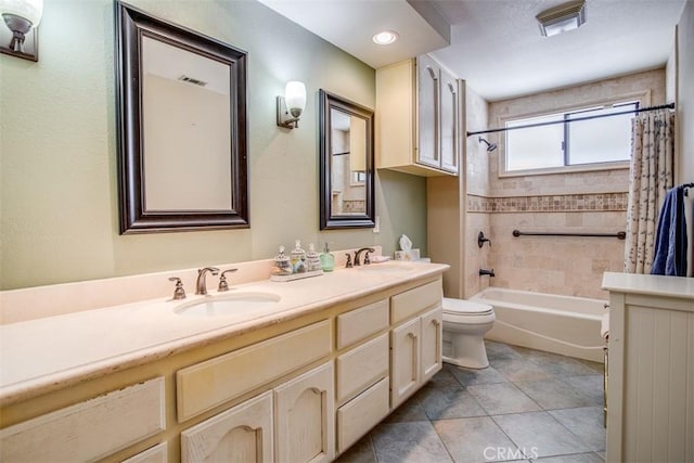 full bathroom with tile patterned flooring, shower / bath combo, vanity, and toilet