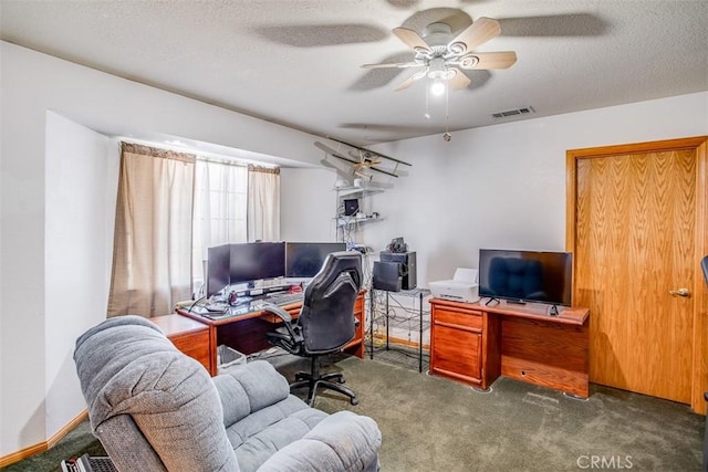 office featuring ceiling fan, dark carpet, and a textured ceiling