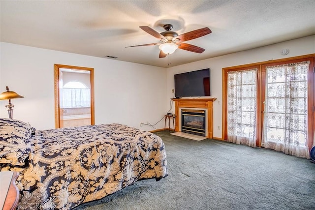 bedroom featuring ceiling fan, carpet flooring, and a textured ceiling