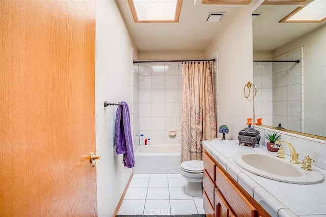 full bathroom with vanity, tile patterned floors, toilet, and shower / bath combo with shower curtain