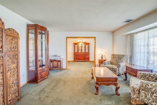 living area featuring carpet, a textured ceiling, and an inviting chandelier