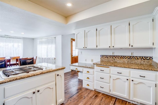 kitchen with gas stovetop, stone countertops, white cabinets, and light hardwood / wood-style floors