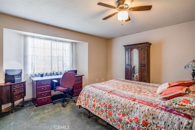 carpeted bedroom with a textured ceiling and ceiling fan