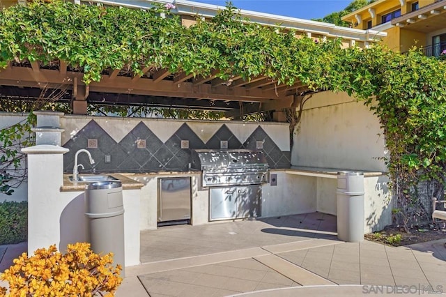 view of patio with grilling area, exterior kitchen, and sink