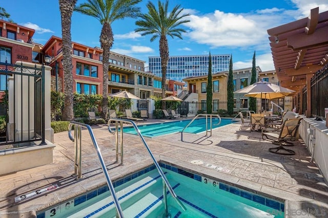 view of pool with a community hot tub and a patio