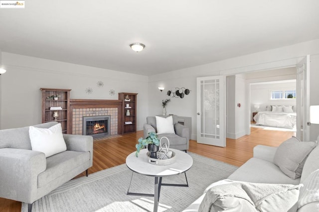 living room with a fireplace and light wood-type flooring