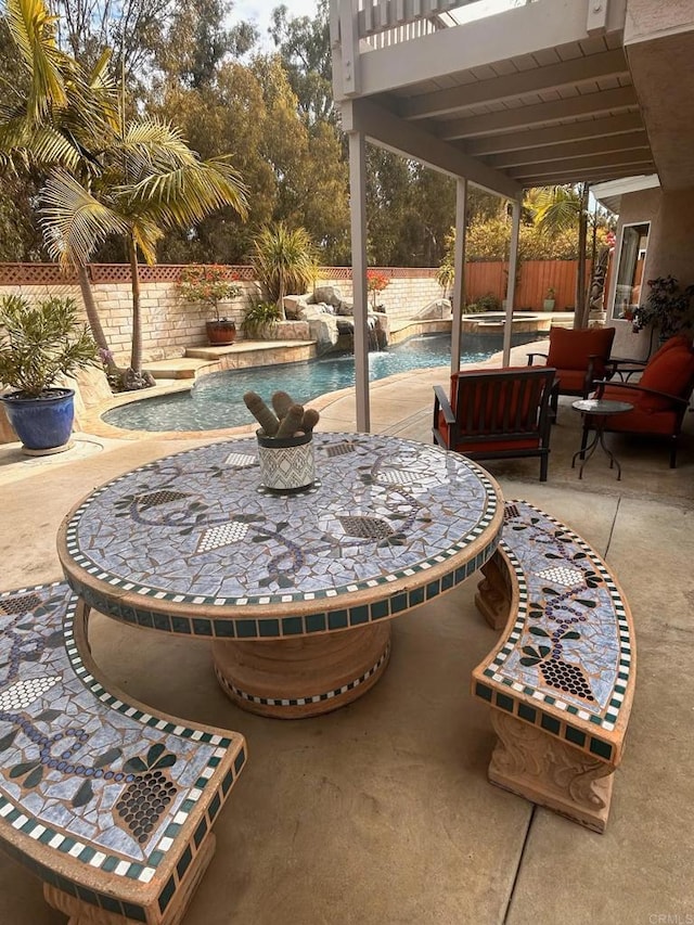 view of patio featuring a fenced in pool and pool water feature