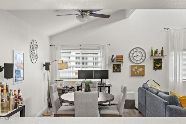 dining room featuring lofted ceiling, wood-type flooring, and ceiling fan