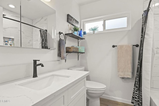 bathroom featuring vanity, wood-type flooring, and toilet