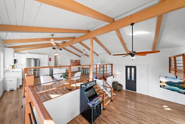 living room featuring lofted ceiling with beams, ceiling fan, and light hardwood / wood-style floors