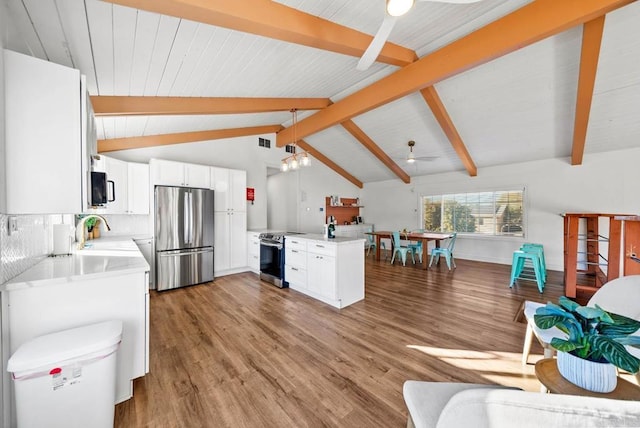 kitchen with stainless steel appliances, pendant lighting, white cabinets, and kitchen peninsula