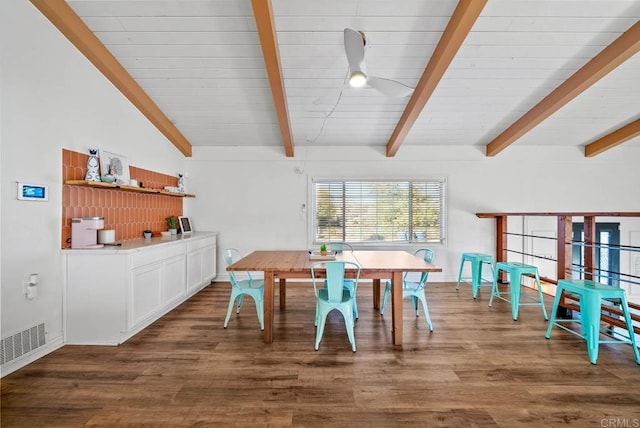 dining area with dark wood-type flooring and lofted ceiling with beams