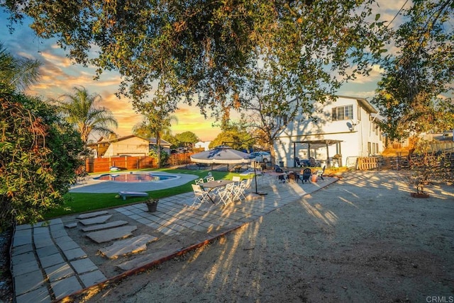 exterior space with a fenced in pool and a patio