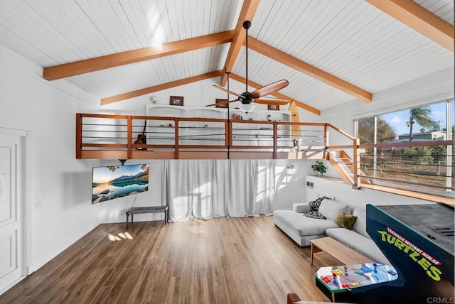 living room featuring ceiling fan, vaulted ceiling with beams, and light wood-type flooring