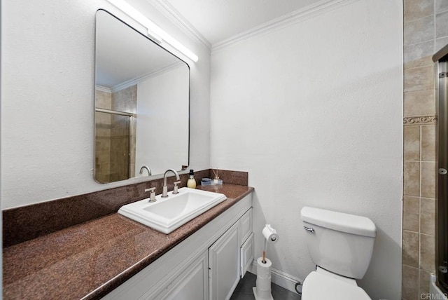 bathroom with vanity, crown molding, a shower with shower door, and toilet