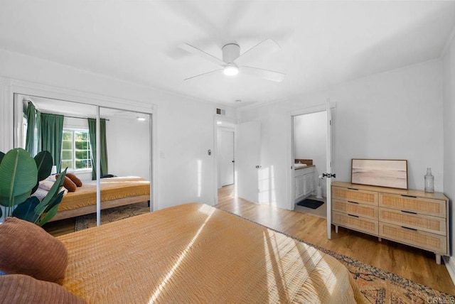 bedroom featuring hardwood / wood-style floors, ceiling fan, and a closet