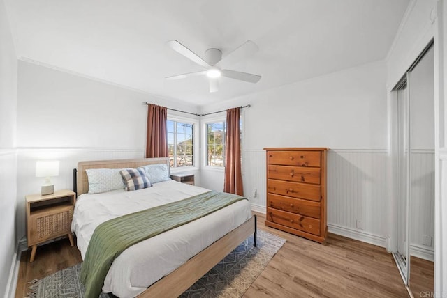 bedroom with hardwood / wood-style floors, a closet, and ceiling fan