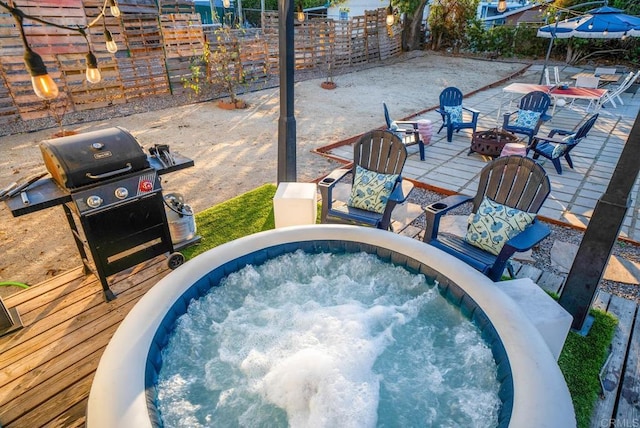 view of swimming pool with a hot tub and grilling area