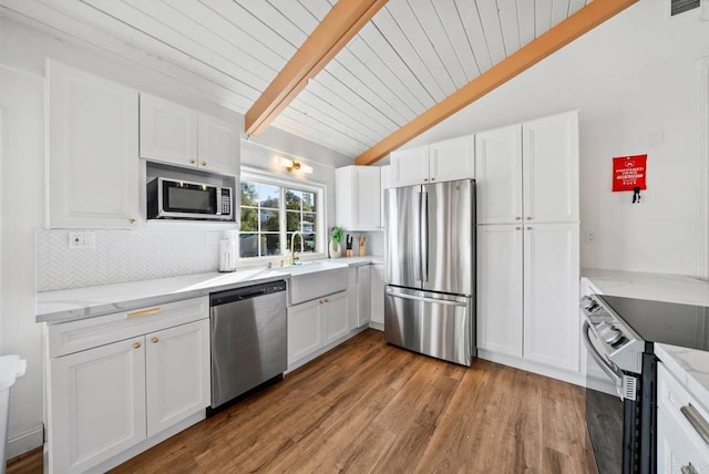 kitchen featuring white cabinetry, appliances with stainless steel finishes, sink, and light stone counters