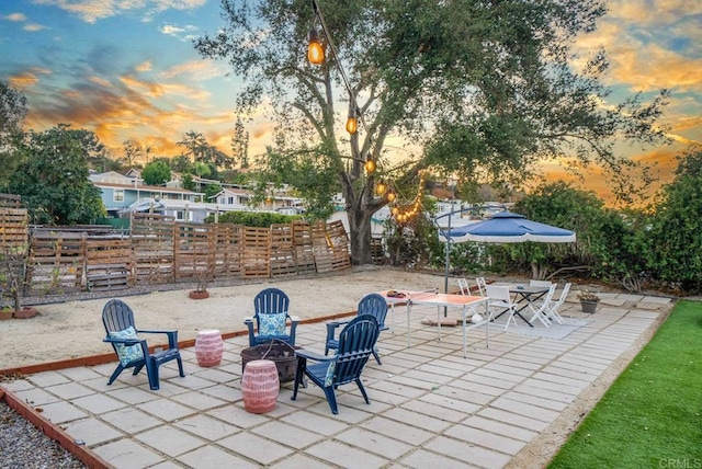 patio terrace at dusk with an outdoor fire pit