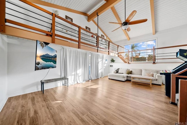 interior space featuring beamed ceiling, wood-type flooring, ceiling fan, and high vaulted ceiling