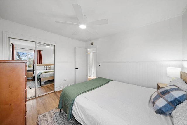 bedroom featuring hardwood / wood-style floors, ceiling fan, and a closet