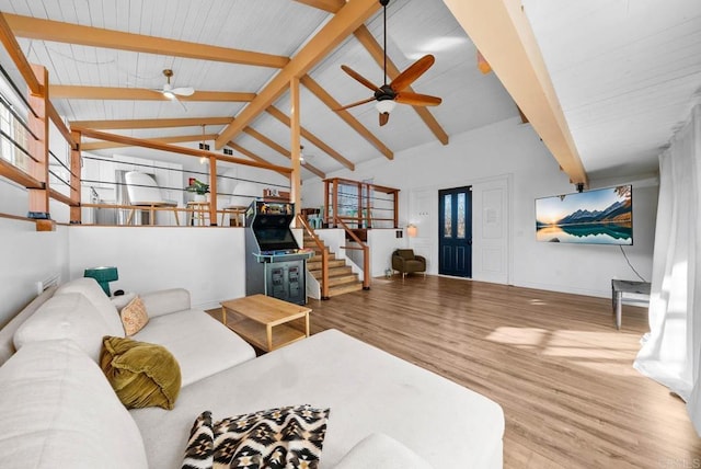 living room with vaulted ceiling with beams, hardwood / wood-style floors, and ceiling fan