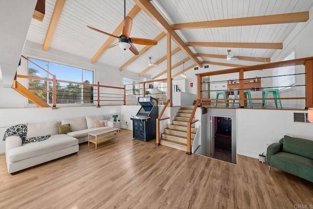 living room with vaulted ceiling with beams, hardwood / wood-style flooring, and ceiling fan