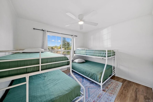 bedroom with ceiling fan and wood-type flooring