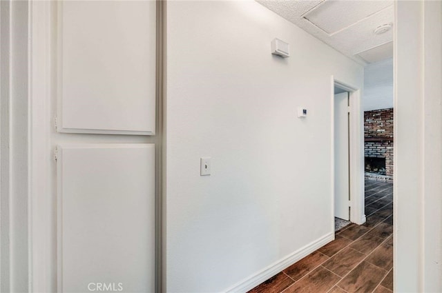 corridor featuring wood finish floors and baseboards