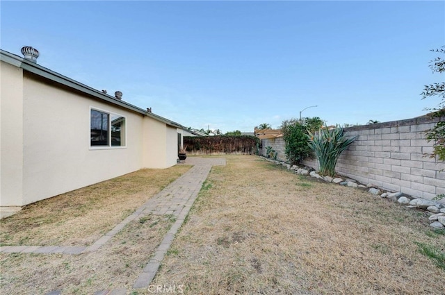 view of yard with a fenced backyard