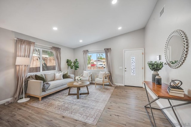 living room with lofted ceiling and light wood-type flooring