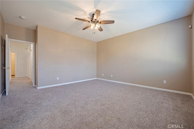 carpeted spare room featuring ceiling fan