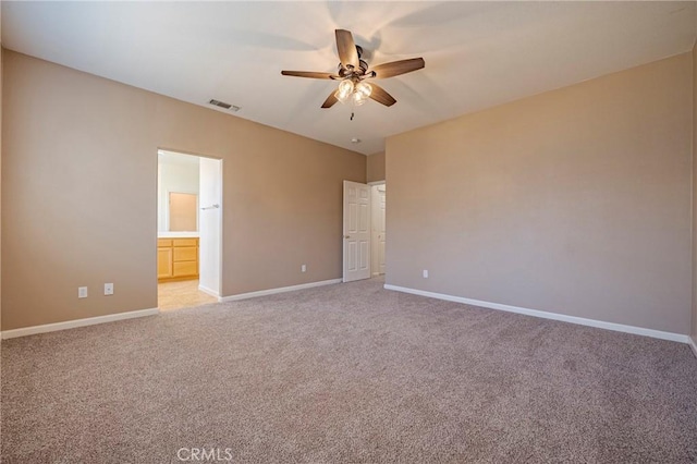 unfurnished bedroom with connected bathroom, light colored carpet, and ceiling fan