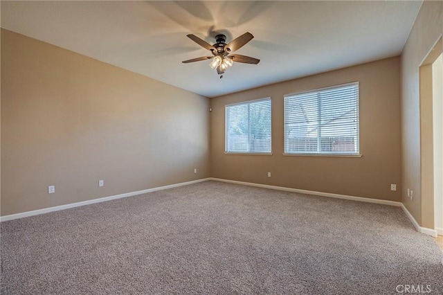 carpeted spare room featuring ceiling fan