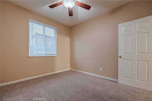 carpeted empty room featuring ceiling fan