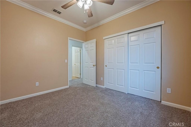 unfurnished bedroom featuring carpet floors, ornamental molding, a closet, and ceiling fan