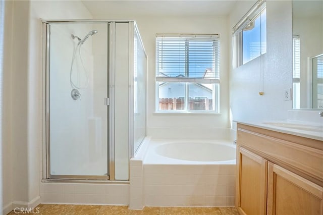 bathroom featuring vanity and separate shower and tub