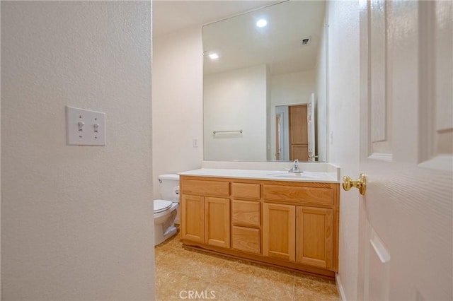 bathroom with vanity and toilet